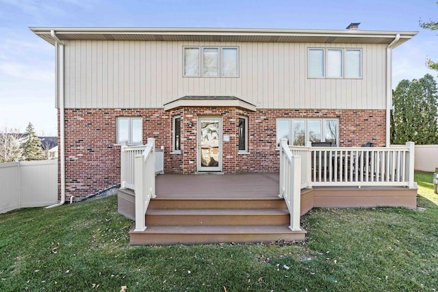 back of property featuring a yard and a deck