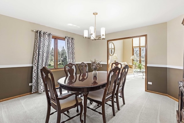 dining room featuring a chandelier and light carpet