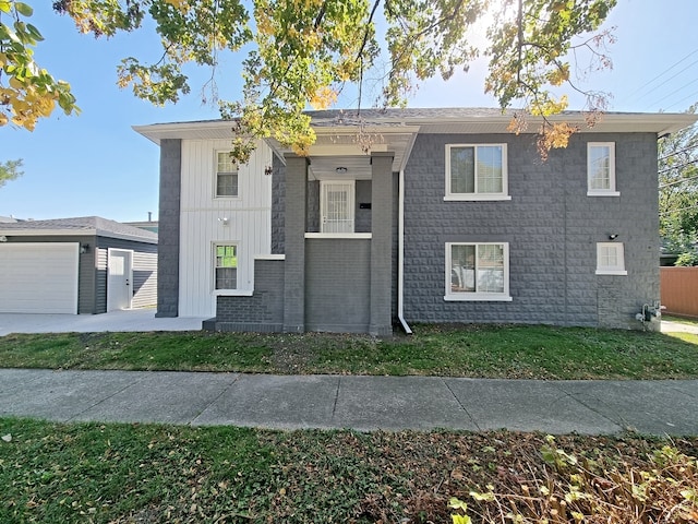 view of front of home with a garage and a front lawn