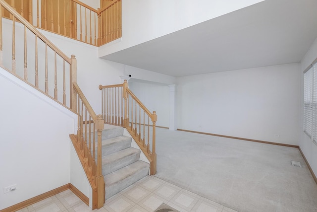 staircase featuring carpet flooring