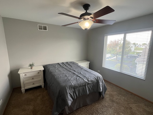 bedroom featuring dark colored carpet and ceiling fan