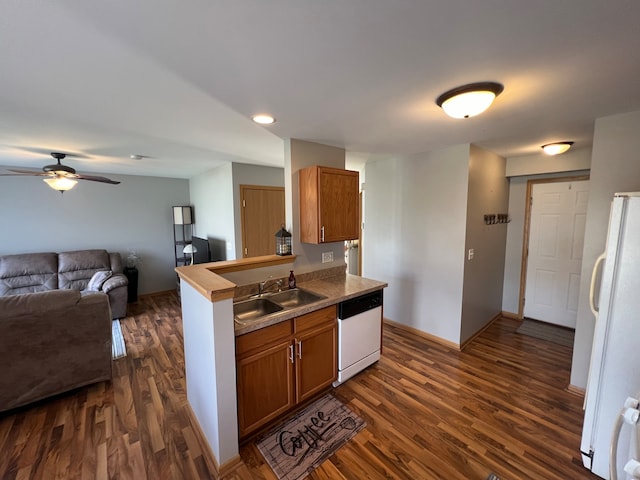 kitchen with dark hardwood / wood-style flooring, ceiling fan, sink, and white appliances