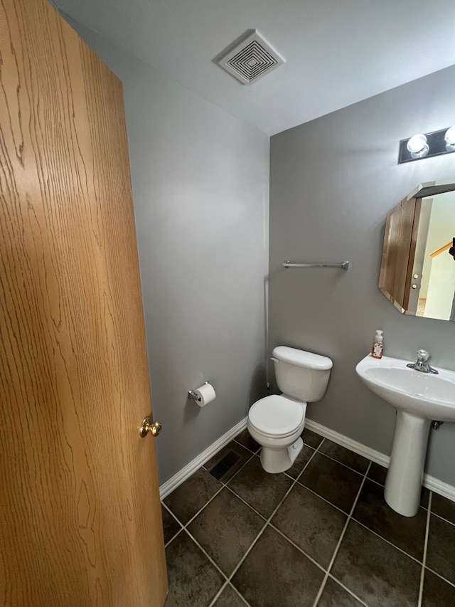 bathroom with tile patterned flooring and toilet