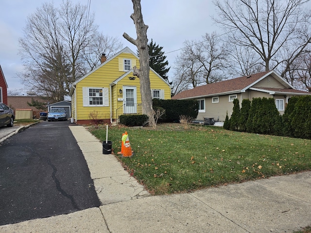 view of front facade featuring a garage, central air condition unit, and a front yard