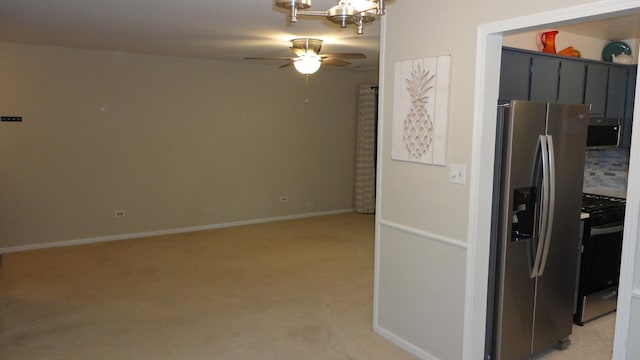 kitchen featuring decorative backsplash, ceiling fan, light carpet, and appliances with stainless steel finishes