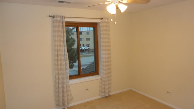 carpeted empty room featuring ceiling fan