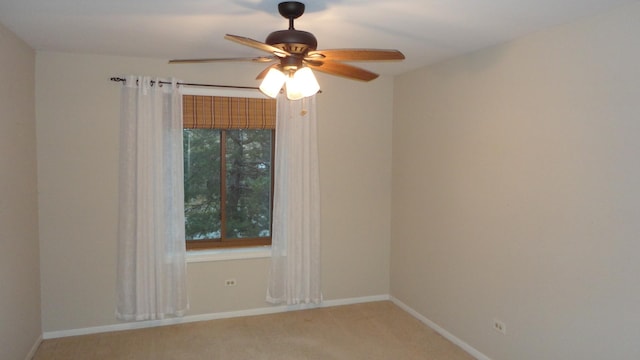 carpeted spare room with ceiling fan