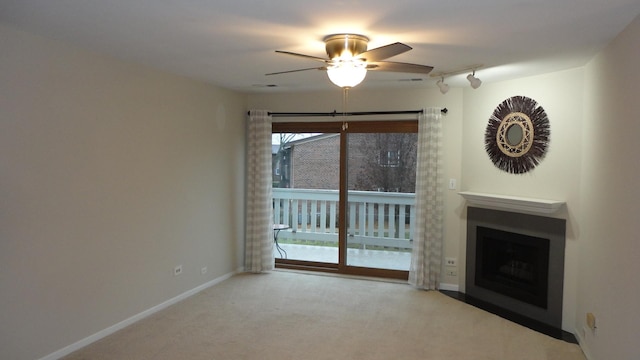 unfurnished living room with ceiling fan and light colored carpet