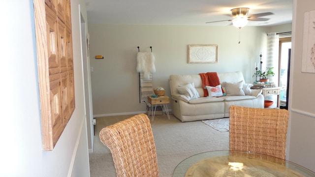 carpeted living room with ceiling fan