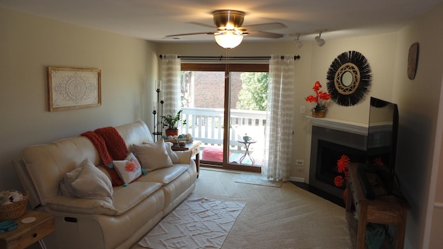 living room featuring light carpet and ceiling fan