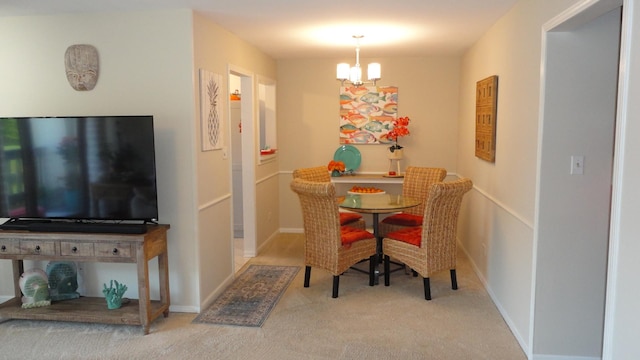 carpeted dining space featuring a notable chandelier