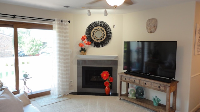 living room featuring ceiling fan, carpet floors, and track lighting