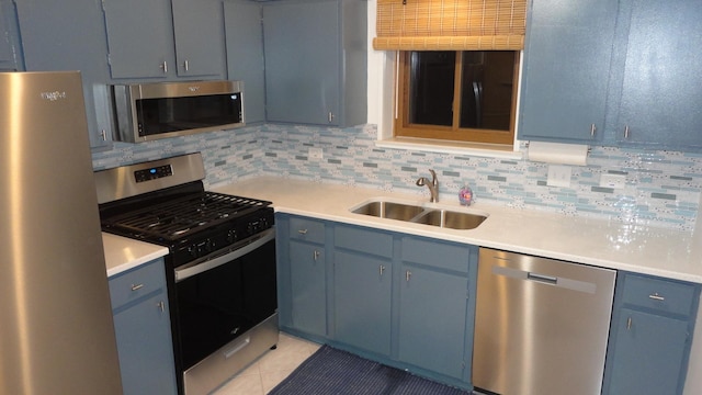 kitchen featuring blue cabinetry, sink, and appliances with stainless steel finishes