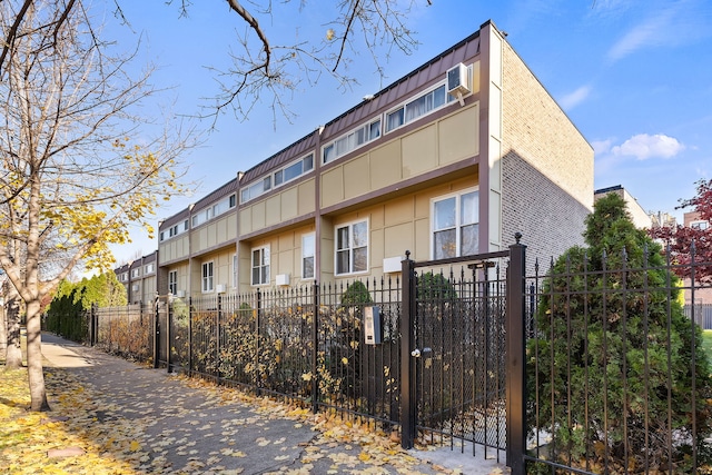 view of building exterior featuring a wall unit AC