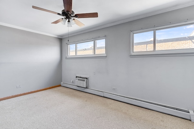 carpeted spare room with a healthy amount of sunlight, crown molding, ceiling fan, and a baseboard heating unit