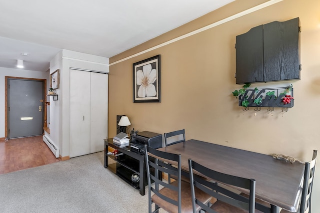 office space featuring light wood-type flooring and baseboard heating