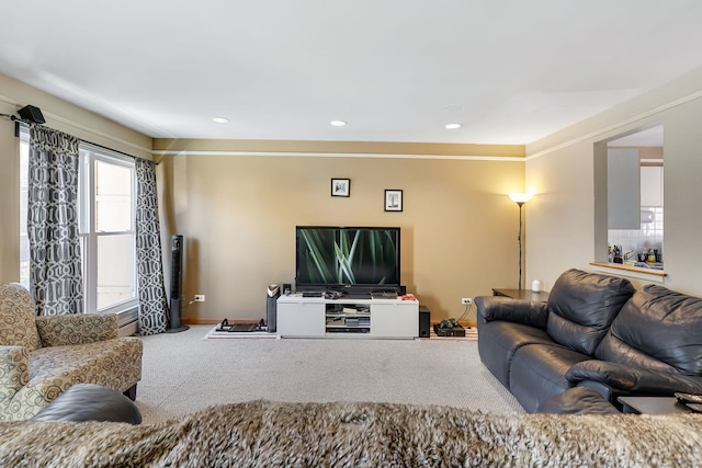 carpeted living room with ornamental molding