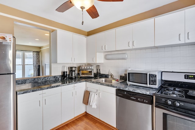 1733 N Larrabee St Unit 0, Chicago, IL 60614 - kitchen with tasteful backsplash, appliances with stainless steel finishes, white cabinets, ceiling fan, and a sink