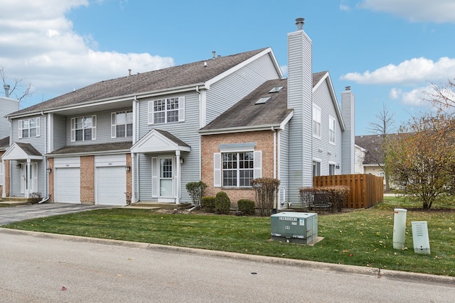 view of front of property with a front yard and a garage