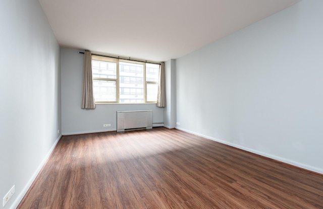 unfurnished room with wood-type flooring