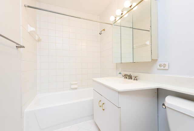 full bathroom featuring vanity, tiled shower / bath combo, and toilet