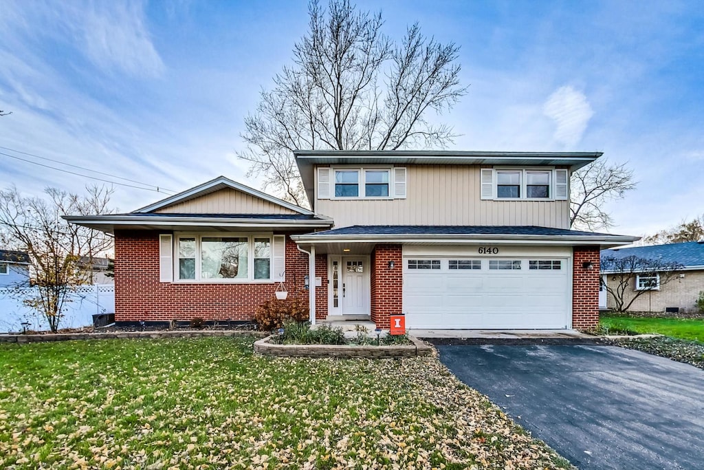 view of front of home featuring a garage and a front lawn