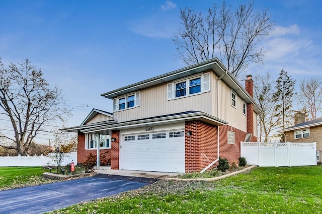 view of front of house with a front lawn and a garage