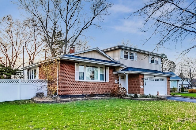 view of front of house with a garage and a front lawn