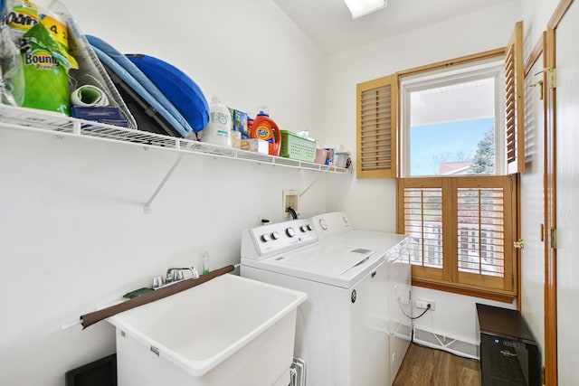 washroom with washer and clothes dryer, dark hardwood / wood-style flooring, and sink