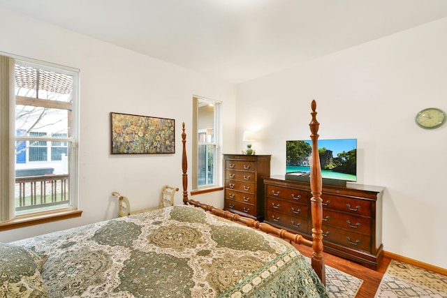 bedroom featuring light hardwood / wood-style flooring and multiple windows