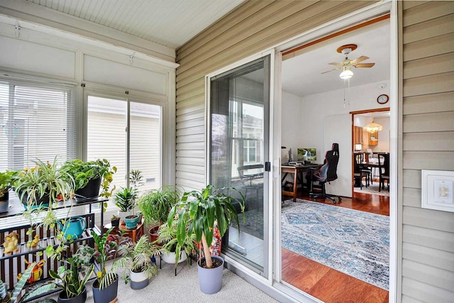 sunroom featuring ceiling fan and a wealth of natural light