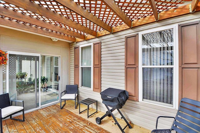 wooden deck with a pergola and a grill