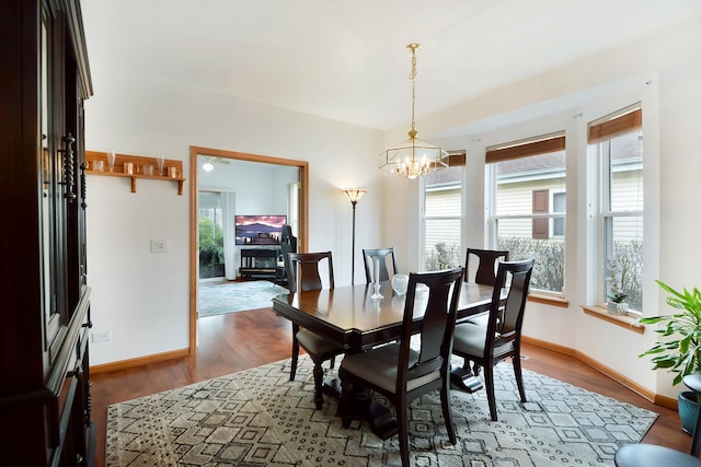 dining space featuring a chandelier and wood-type flooring