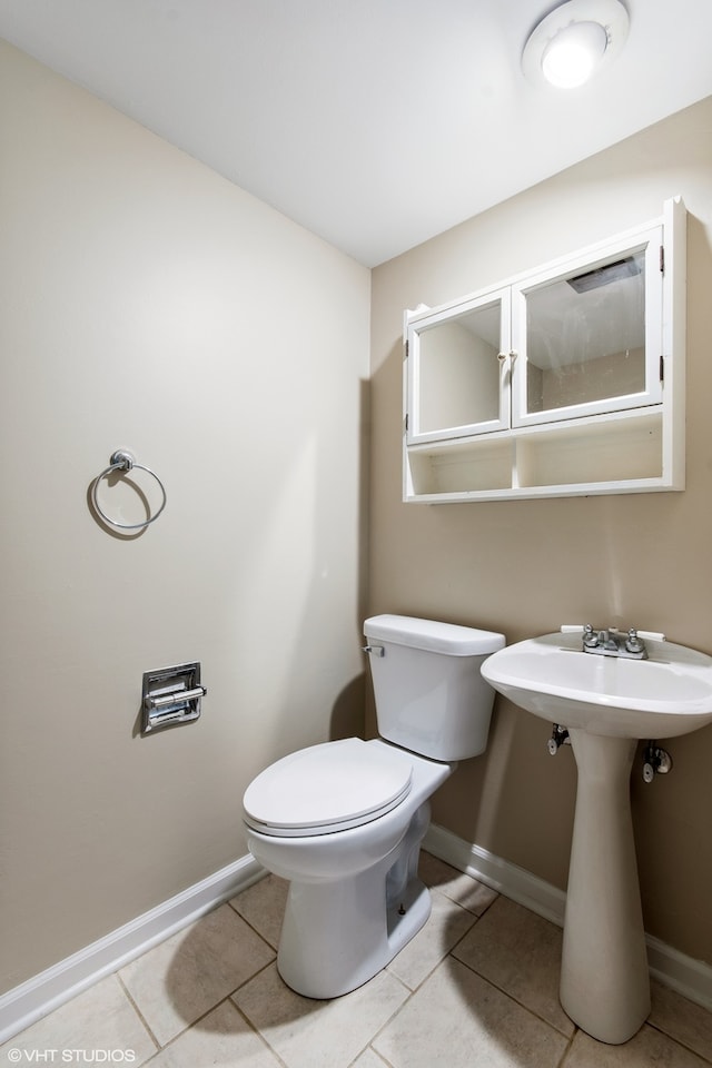 bathroom with tile patterned floors and toilet