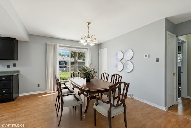 dining space featuring a notable chandelier and light hardwood / wood-style flooring