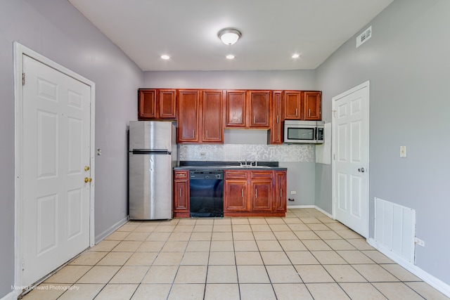 kitchen featuring light tile patterned floors, stainless steel appliances, tasteful backsplash, and sink