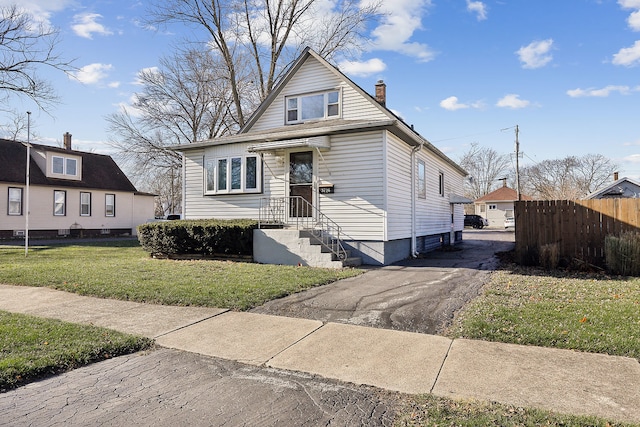 bungalow-style house with a front yard