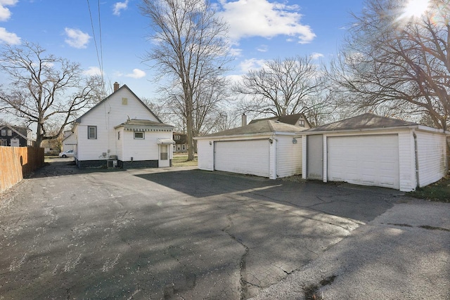 view of home's exterior featuring an outbuilding and a garage