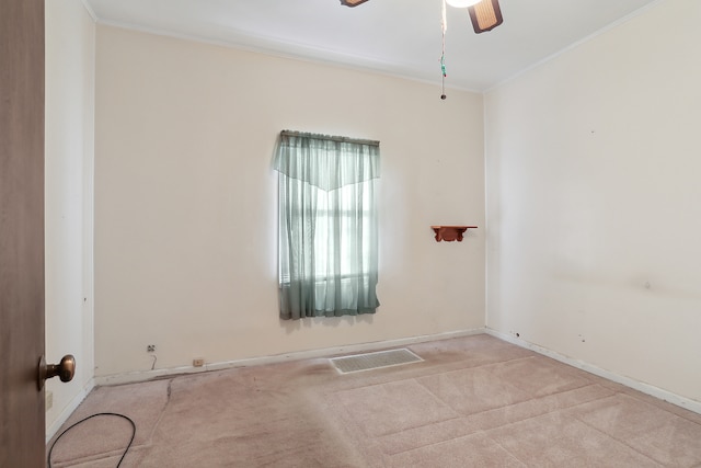 carpeted spare room with ornamental molding and ceiling fan