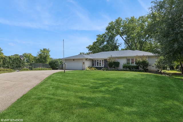 ranch-style house featuring a front yard and a garage