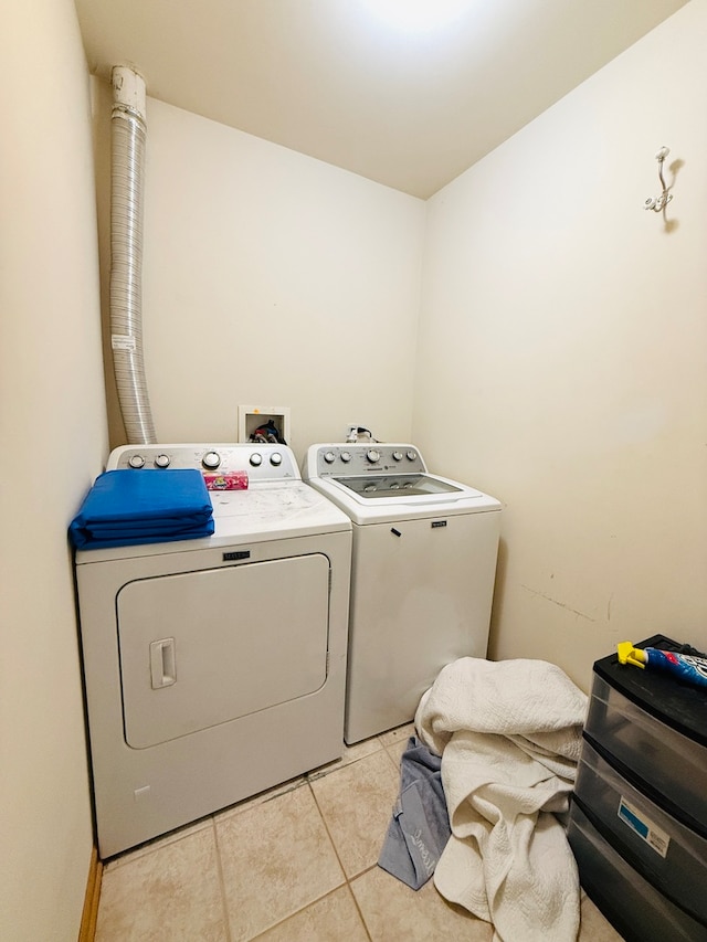 washroom featuring separate washer and dryer and light tile patterned floors