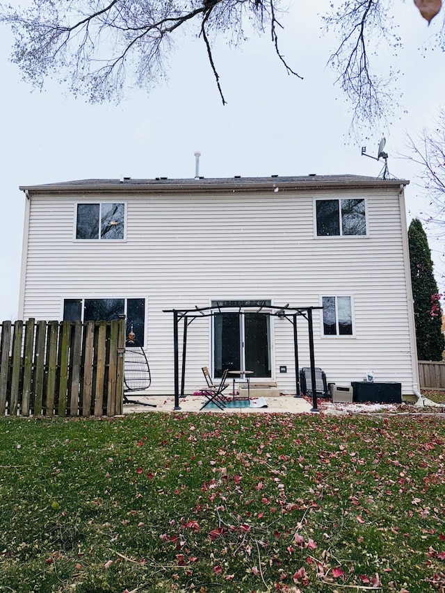 rear view of property with a yard, a pergola, and a patio