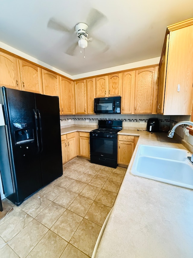 kitchen with ceiling fan, sink, tasteful backsplash, light tile patterned floors, and black appliances