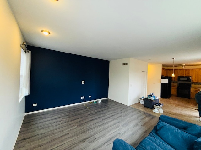 unfurnished living room with wood-type flooring