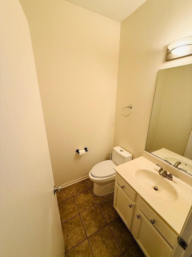 bathroom featuring tile patterned flooring, vanity, and toilet