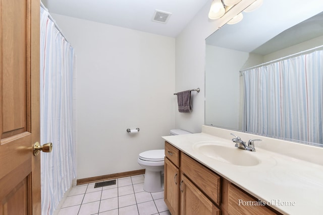 bathroom featuring vanity, tile patterned floors, and toilet