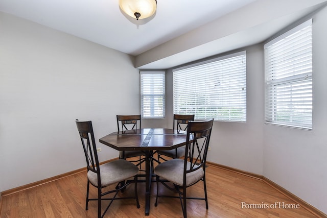 dining space with a wealth of natural light and light hardwood / wood-style flooring