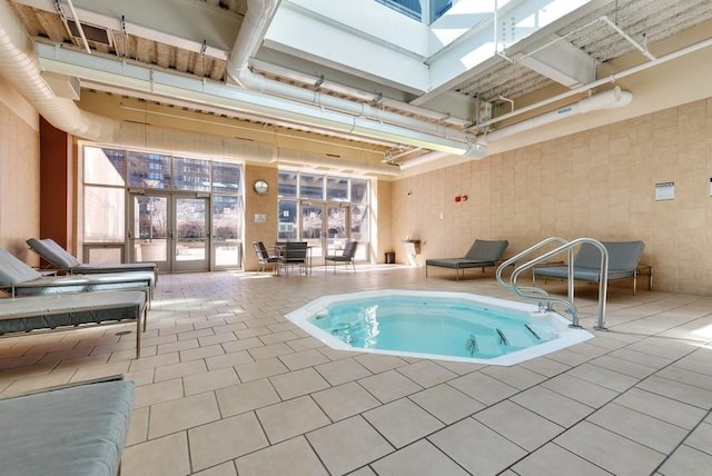 view of pool with french doors and an indoor hot tub