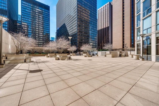 view of property's community with a view of city and a patio area