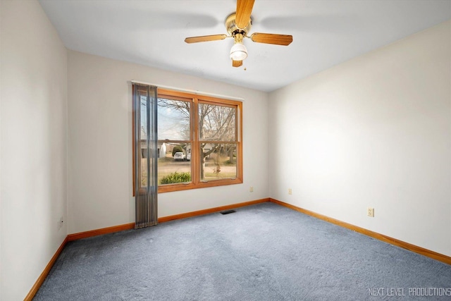 carpeted empty room featuring ceiling fan